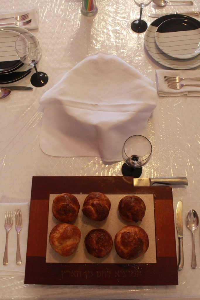 Table set for Shavuos Night. The significance of the 6 rolls is that a standard cupcake tray has room for 6 cupcakes!