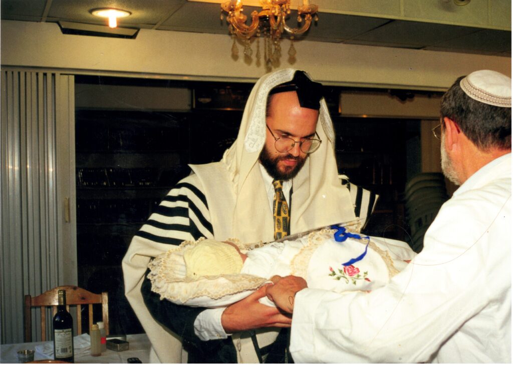 Holding Yitzchak Meir - with the hospital's Mohel