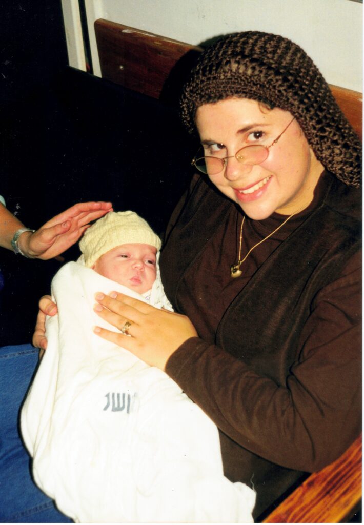 Mother holding YItzchak Meir after the bris